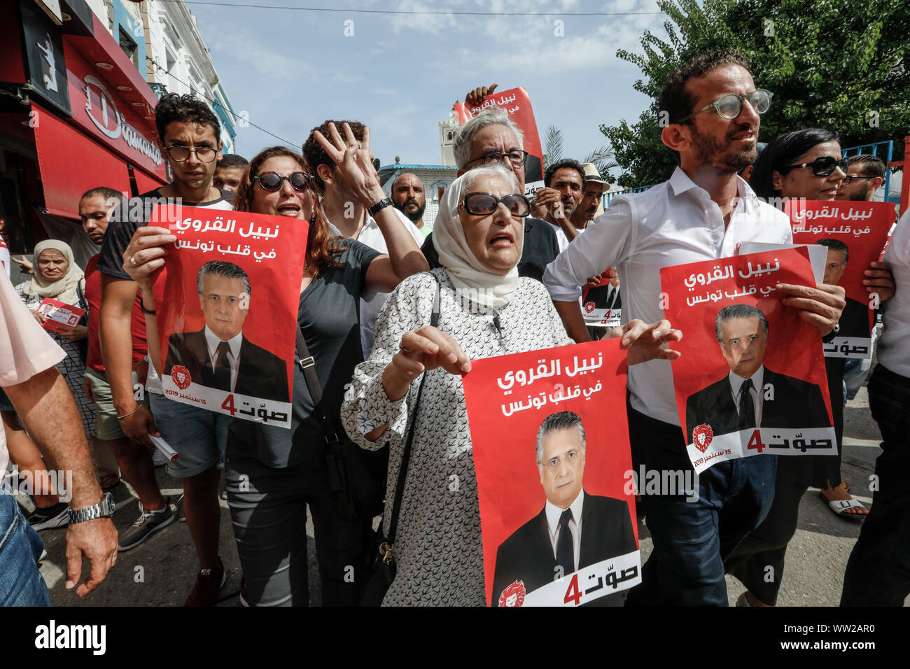 Bizerte, Tunisia. Xii Sep, 2019. I sostenitori di imprenditore tunisino e media mogul, Nabil Karoui, che è stato arrestato per riciclaggio di denaro e la frode fiscale, tenere la campagna elettorale manifesti durante una manifestazione di protesta per rendere il contatto diretto con gli elettori giorni prima pre-elettorale in silenzio. Nabil Karoui, uno anteriore delle guide di scorrimento nel paese presidenziali sondaggi di questo weekend, iniziato uno sciopero della fame il giovedì per protestare contro la sua carcerazione, una sorgente nella sua campagna detto. Il primo turno delle elezioni presidenziali si terrà il 15 settembre 2019. Credito: Khaled Nasraoui/dpa/Alamy Live News Foto Stock