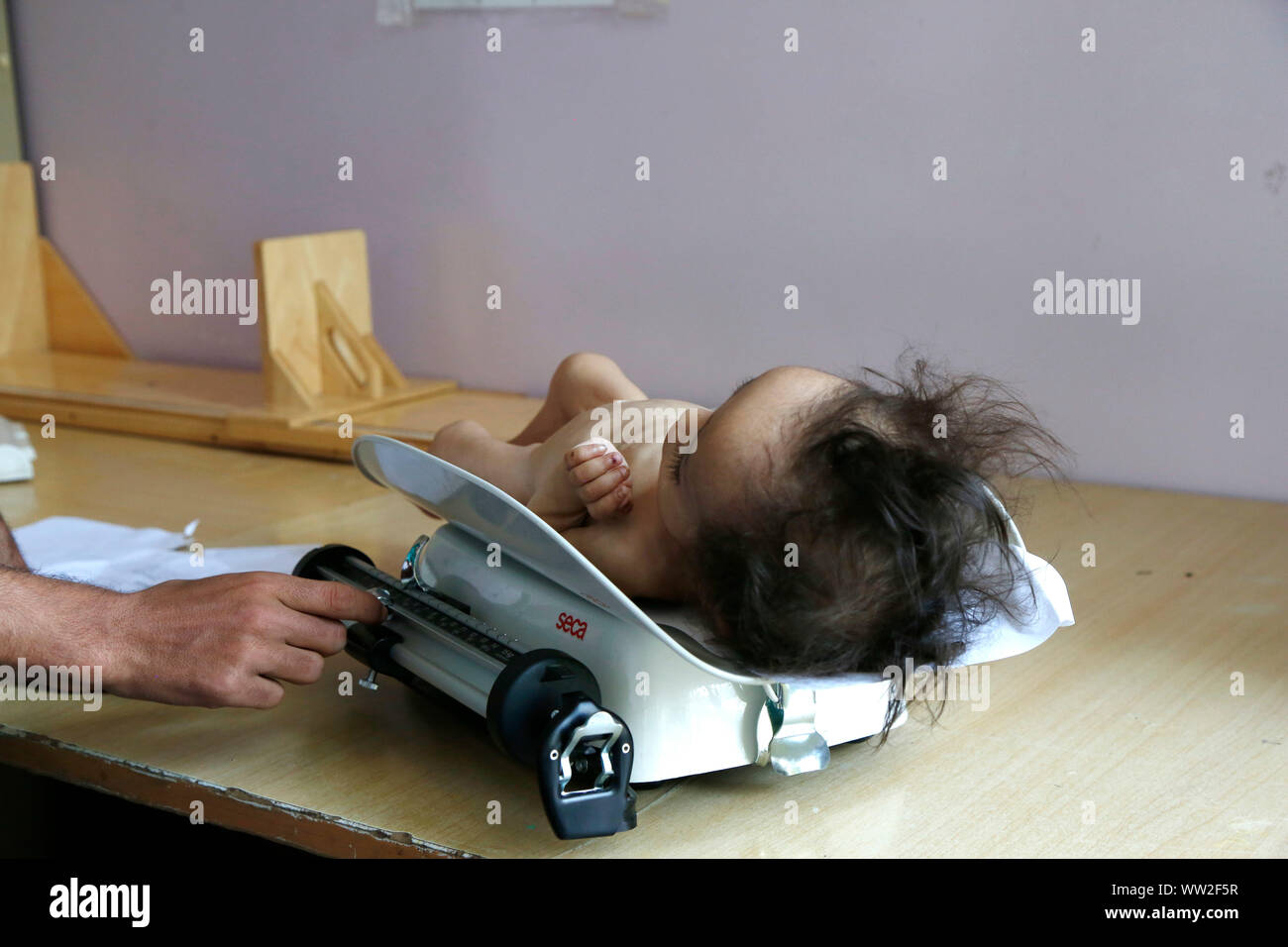 (190912) -- SANAA, Sett. 12, 2019 (Xinhua) -- Un medico pesa un bambini malnutriti in corrispondenza di un anti-malnutrizione centro di trattamento in ospedale Sabeen in Sanaa, Yemen, sul Sett. 12, 2019. Secondo una relazione pubblicata dall'UNICEF sulla luglio 31, circa 357 migliaia di bambini al di sotto dei 5 anni soffrono di malnutrizione severa acuta (SAM) in Yemen. (Foto di Mohammed Mohammed/Xinhua) Foto Stock