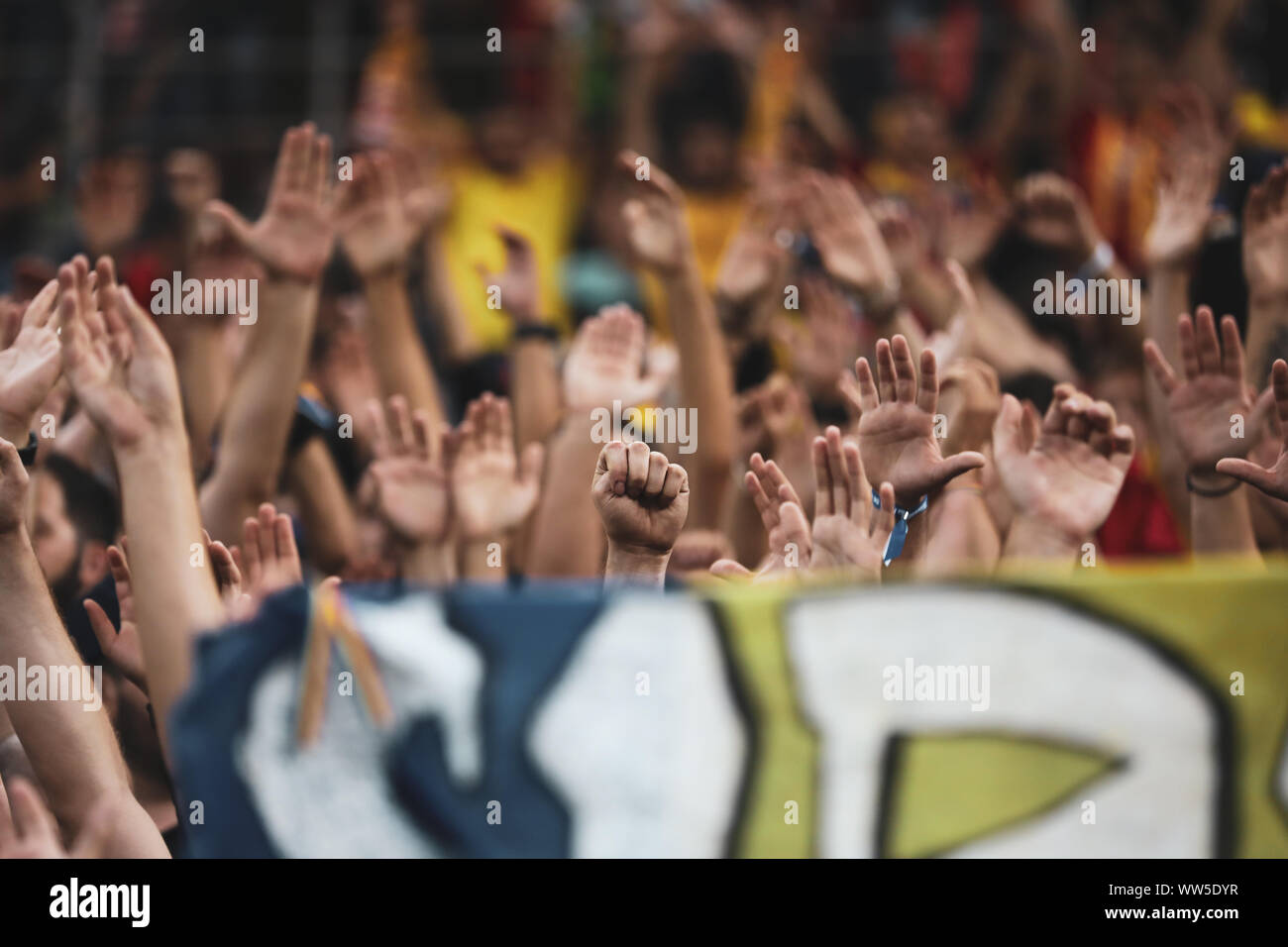 Dettagli con un pugno e le mani dei tifosi di calcio durante una partita Foto Stock