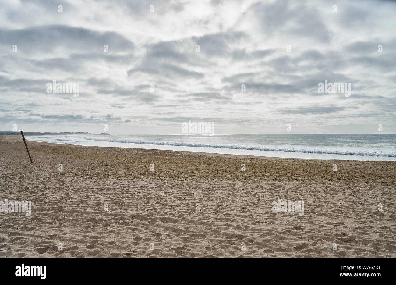 Spiaggia dal mare, surf, onde, nuvole scure Foto Stock