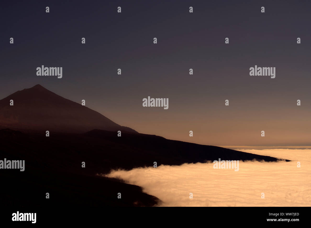 Sunrise, commercio vento nuvole sotto il Pico del Teide, Parco Nazionale di Teide Tenerife, Isole Canarie, Spagna Foto Stock