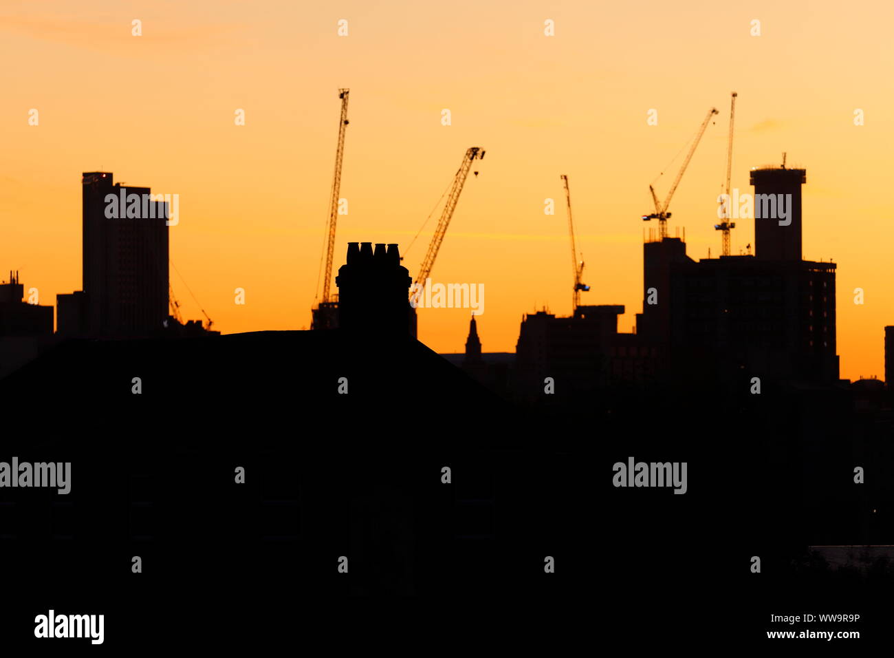 Silhouette di Leeds skyline durante il sunrise. Yorkshire il nuovissimo edificio più alto "Altus House' è in costruzione tra gli altri edifici di nuova costruzione. Foto Stock