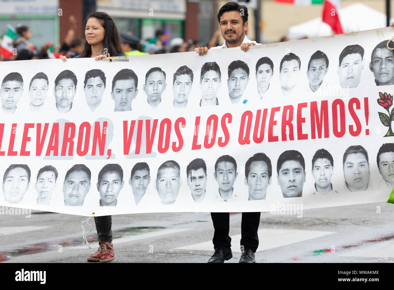 Chicago, Illinois, Stati Uniti d'America - 8 Settembre 2019: 26th Street indipendenza messicana Parade, l uomo e la donna tenendo un banner con le foto degli studenti mancanti Foto Stock