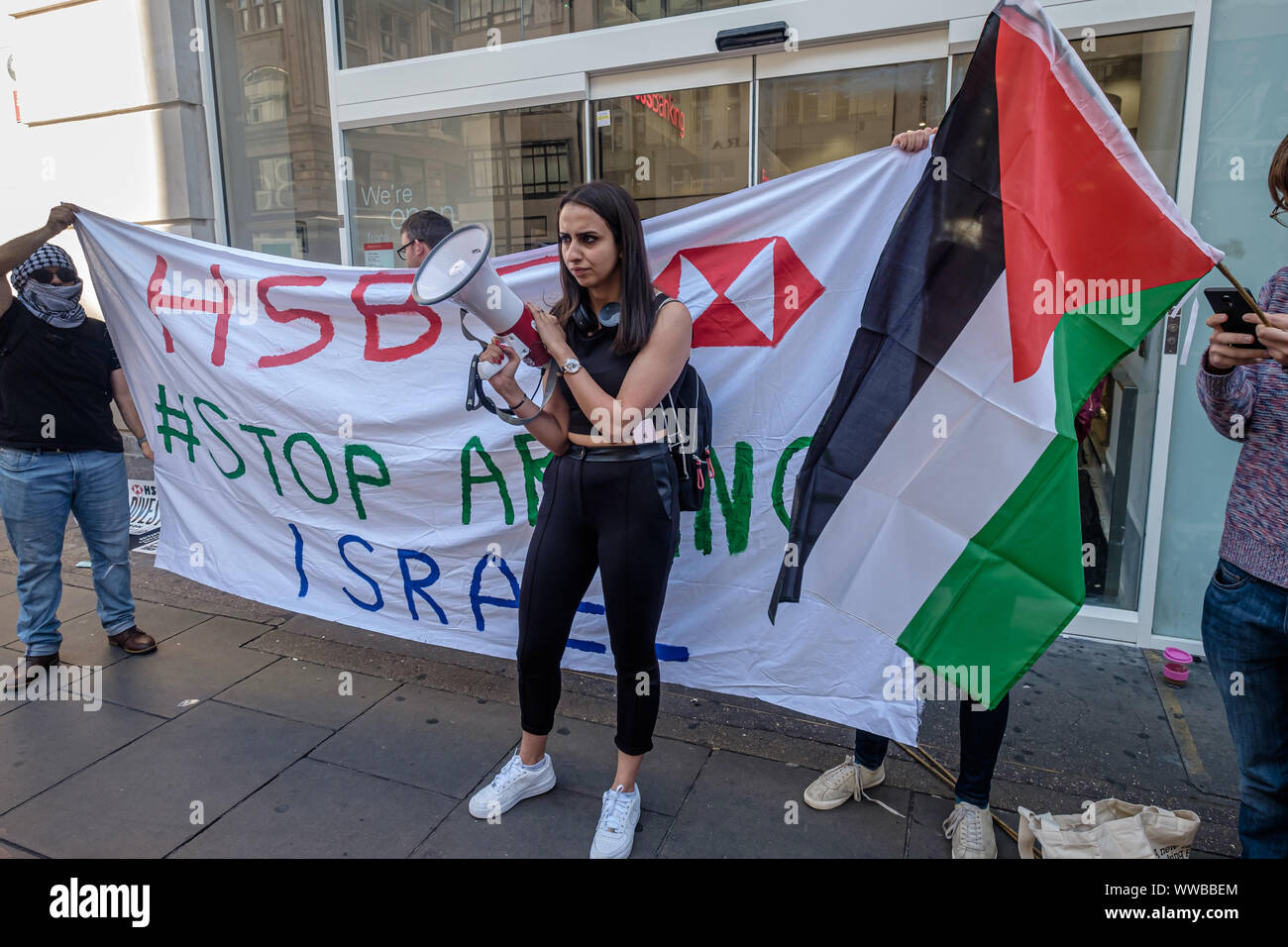 Londra, Regno Unito. 14 settembre 2019. I dimostranti fuori Oxford St filiale della banca HSBC chiamare su di esso per interrompere il suo supporto di militari e di aziende tecnologiche che vendono armi e attrezzature di Israele per essere utilizzate contro i palestinesi. HSBC ha ceduto da Israele la privata più grande azienda di armi, ma ancora possiede partecipazioni in Caterpillar che alimenta i bulldozer a distruggere case palestinesi e la costruzione illegale settlemetns apartheid. Credito: Peter Marshall / Alamy Live News Foto Stock