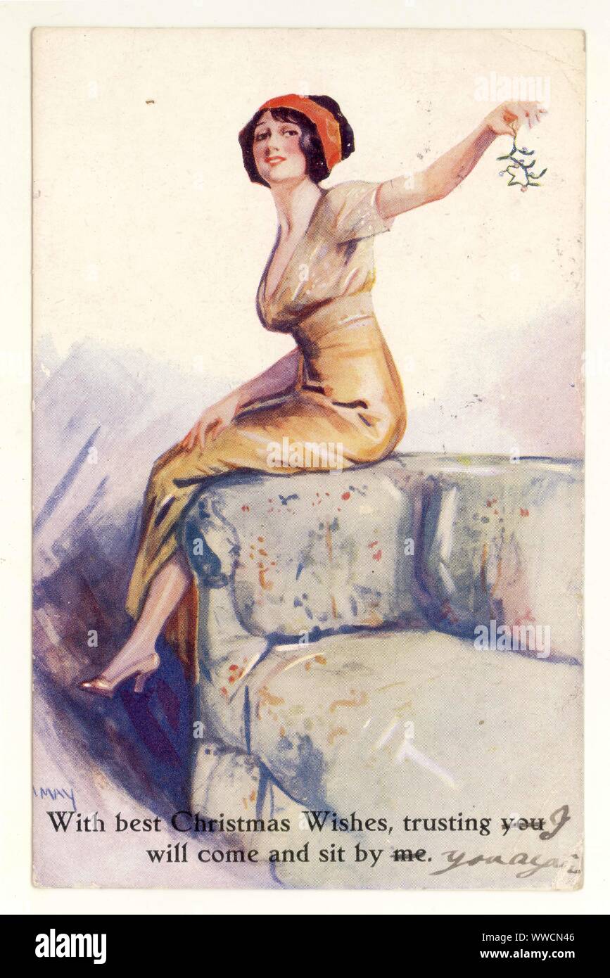 Primi del novecento WW1 era illustrato gli auguri di Natale cartolina di glamour, flirtatious donna, un po' impertinente al momento come mostra la caviglia e azienda vischio, 1914, U.K. Foto Stock