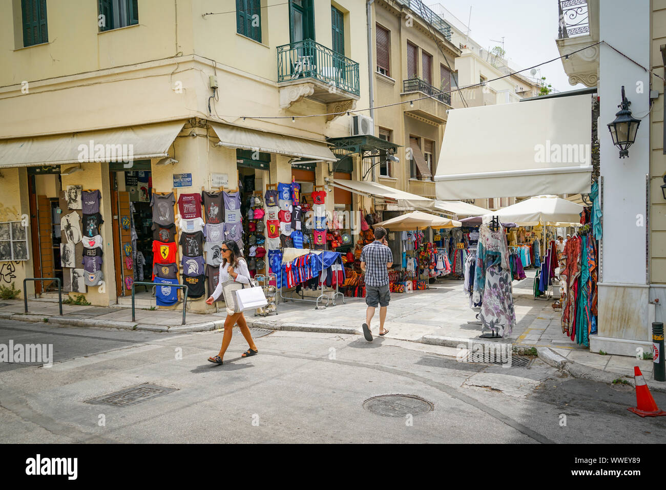 Atene GRECIA - Luglio 15 2019; Plaka angolo di strada con tee shirt shop e uomo e donna Foto Stock