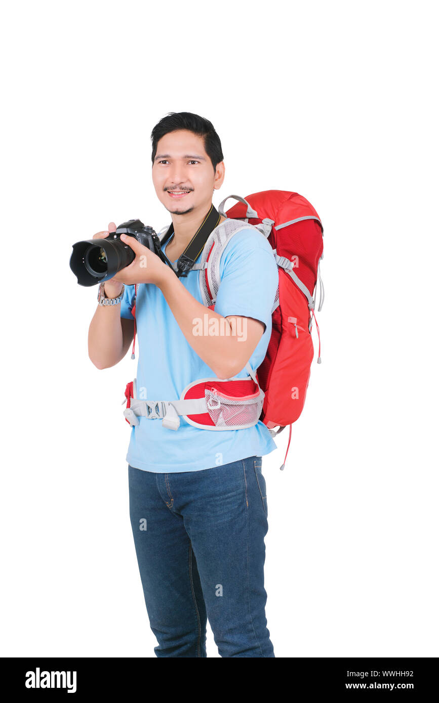 Uomo asiatico con uno zaino in possesso di una fotocamera per scattare foto isolate su sfondo bianco Foto Stock