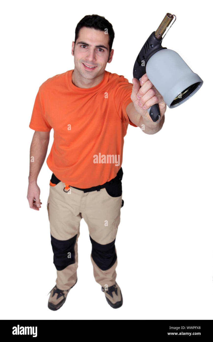 Uomo con TORCIA SOFFIANTE Foto Stock
