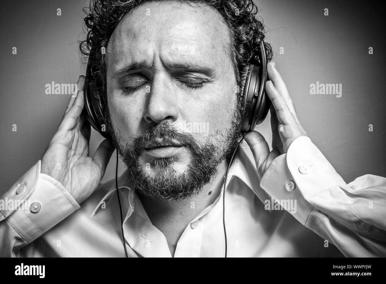 Godetevi la musica, l'uomo con intensa espressione, camicia bianca Foto Stock