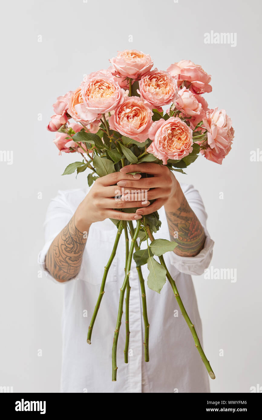 La ragazza è in possesso di un mazzo di fiori di rosa fresca roses, Foto Stock