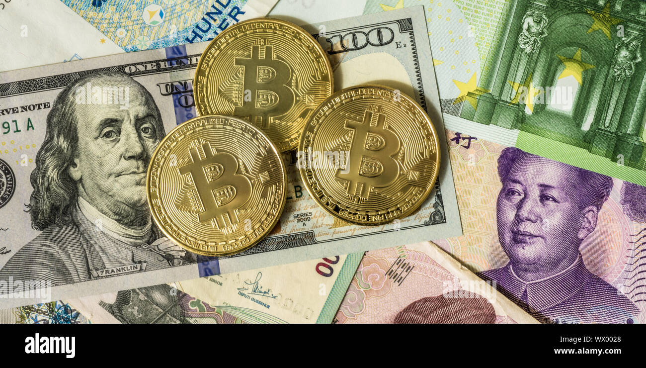Golden bitcoin su multi valuta banconote dollaro, yuan, euro Foto Stock