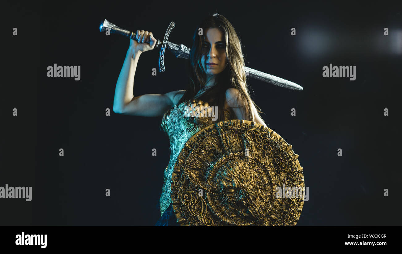 Storia valkyrie guerriero, donna con golden armor rivestire di ferro e grande guerriero spada Foto Stock