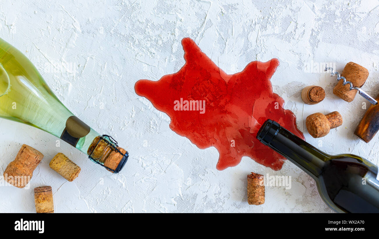 Bottiglie di vino bianco e rosso, i tappi di sughero e un vecchio cavatappi. Foto Stock