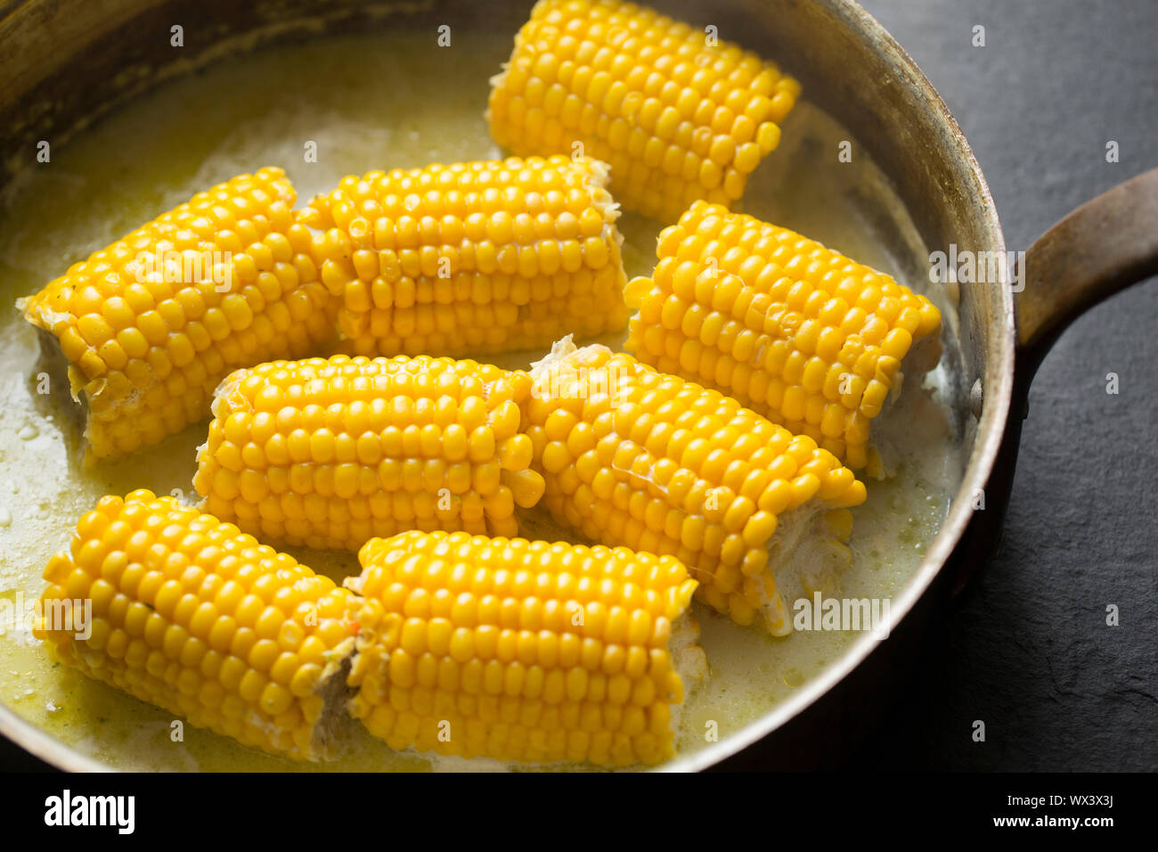 British sulla pannocchia di mais che è stato acquistato da un Supermercato UK e cotto a fuoco lento in una pentola di rame con il latte, il burro e il brodo vegetale. Inghilterra REGNO UNITO GB Foto Stock