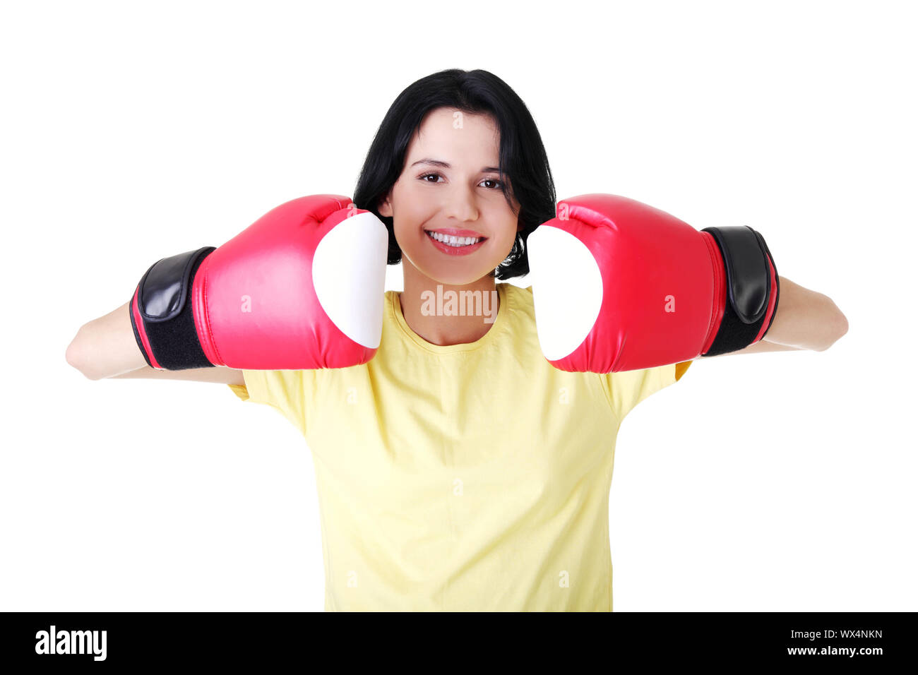 Giovane donna che indossa un paio di guanti da boxe. Studente donna pronta per gli esami Foto Stock