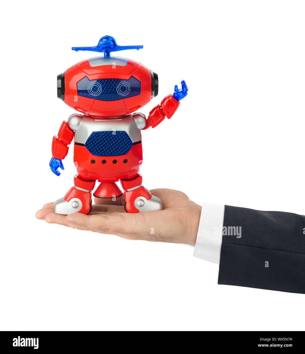 Mano con robot giocattolo Foto Stock