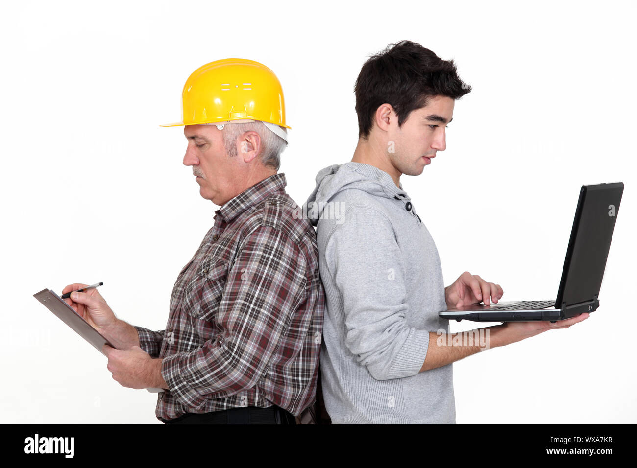 Lavoratore manuale stava schiena a schiena con adolescente Foto Stock