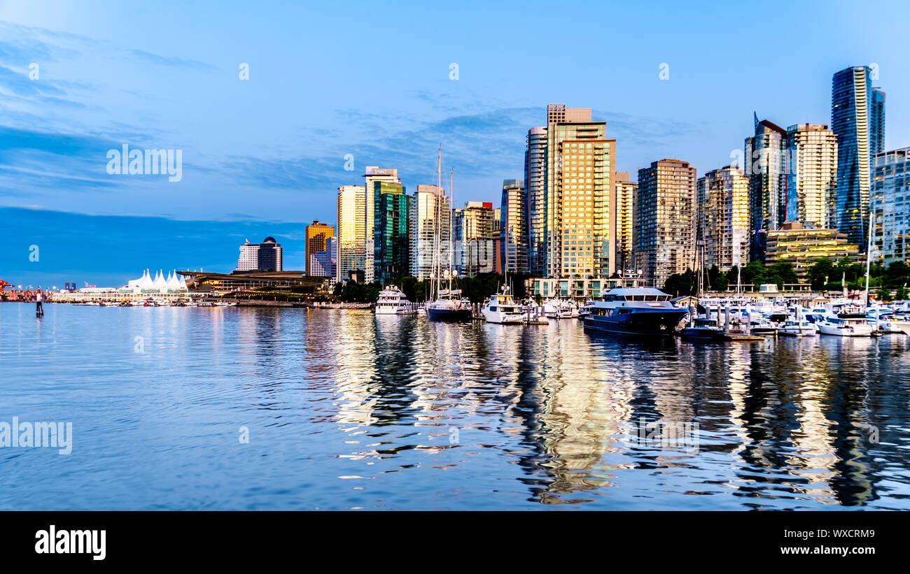 Tramonto sul alti edifici che formano il centro e il porto di carbone skyline. Vista dal porto di una nave da crociera nel porto di Vancouver in BC Foto Stock