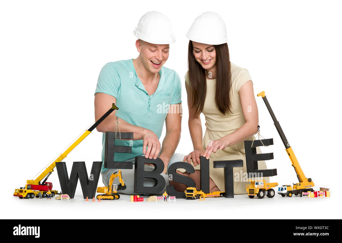 Sito web in costruzione: Gioiosa l uomo e la donna edificio sito web-parola. Foto Stock