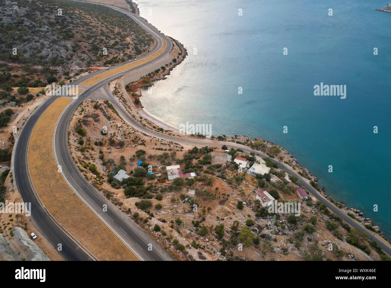Intersezione di due strade tortuose e del litorale del mare al mattino. Vista aerea Foto Stock