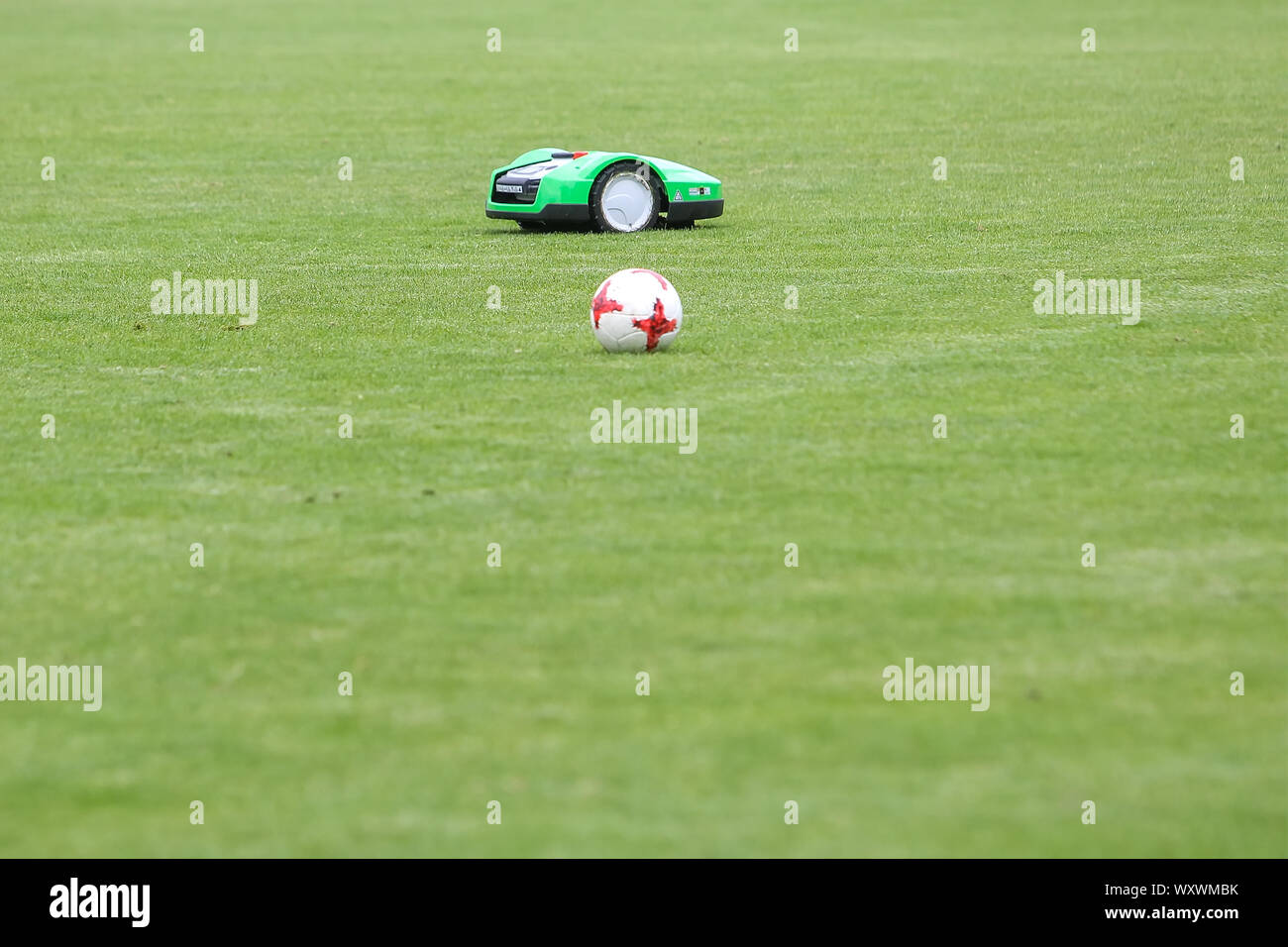 Oosterbeek, Paesi Bassi - Luglio 11, 2018: Automatico tosaerba robotizzati su erba verde nello stadio. Falciare il prato con un robot. Foto Stock