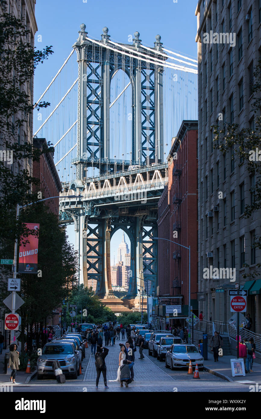 Sposa e lo Sposo posa per fotografie di Manhattan Bridge da DUMBO quartiere (verso il basso al di sotto del ponte di Manhattan cavalcavia) Brooklyn, New York City Foto Stock