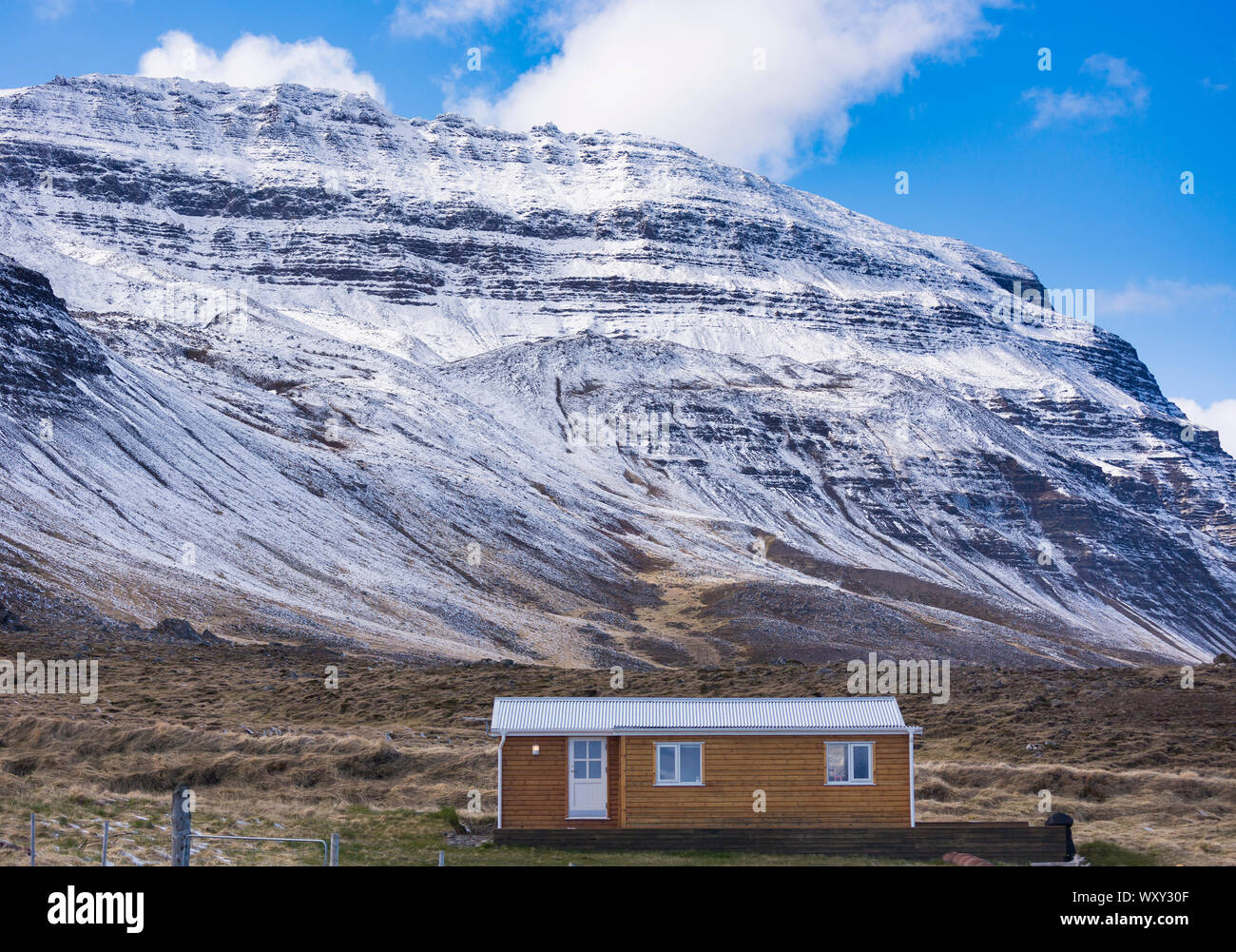 REYKIR-GRETTISLAUG, Islanda - Piccolo edificio e montagna sul fiordo di Skagafjordur. Foto Stock