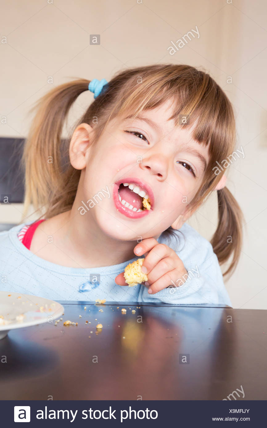 Ritratto Di Bambina Di Mangiare La Torta Con La Bocca Aperta Foto Stock Alamy